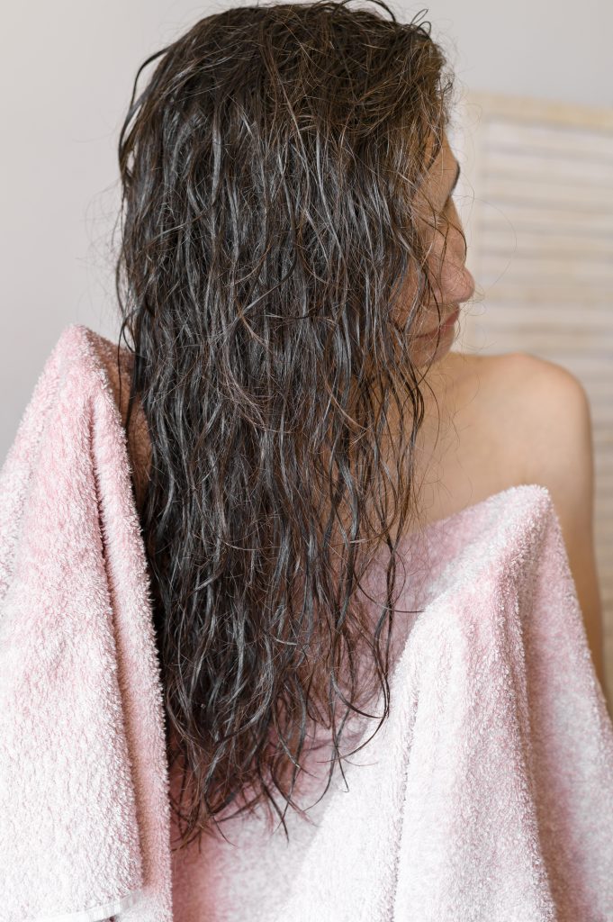 woman taking care of her hair using bond care products