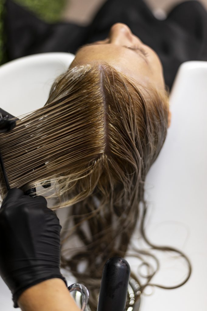 woman during her hair appointment getting her hair prepped and washed